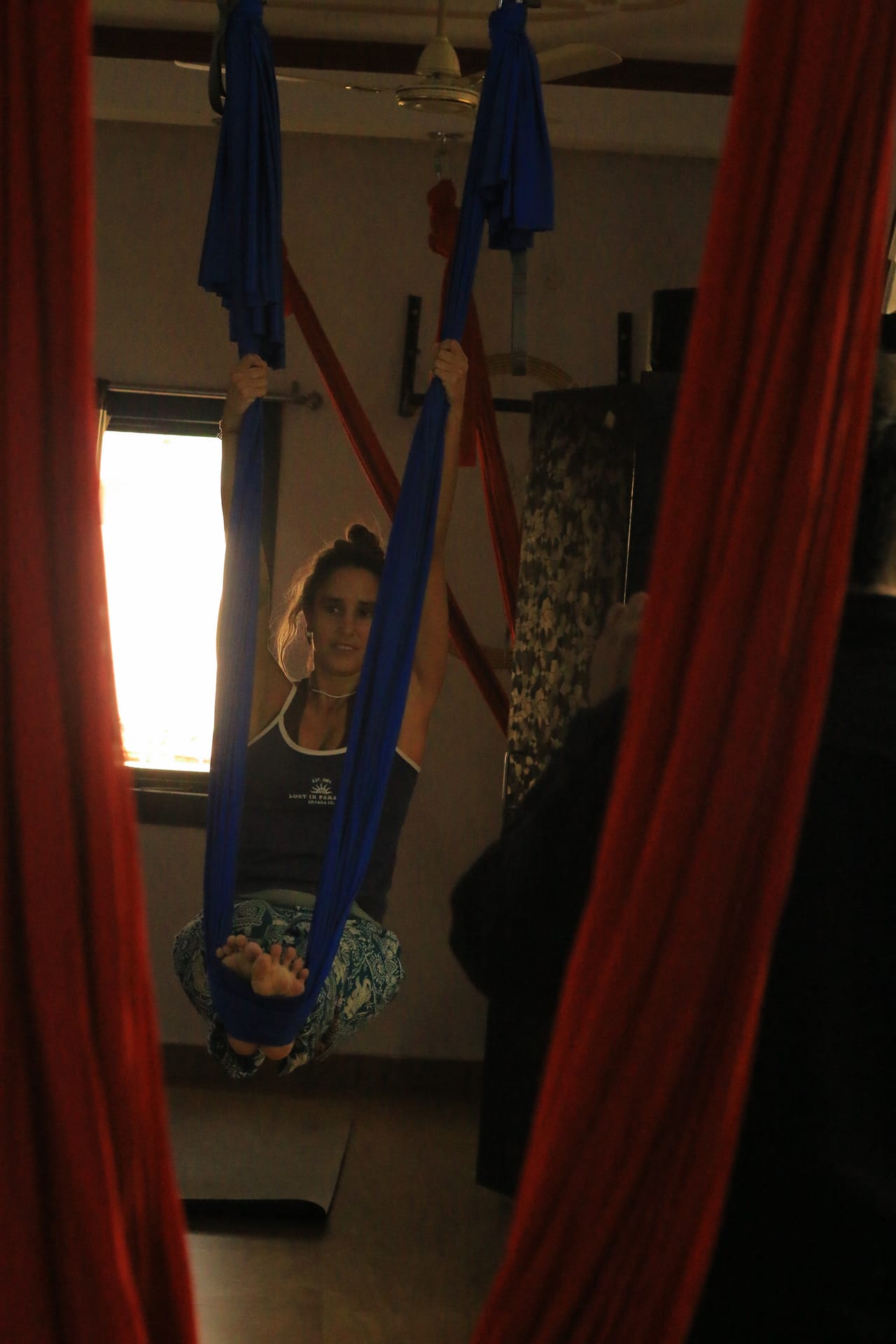 Student in aerial yoga cocoon