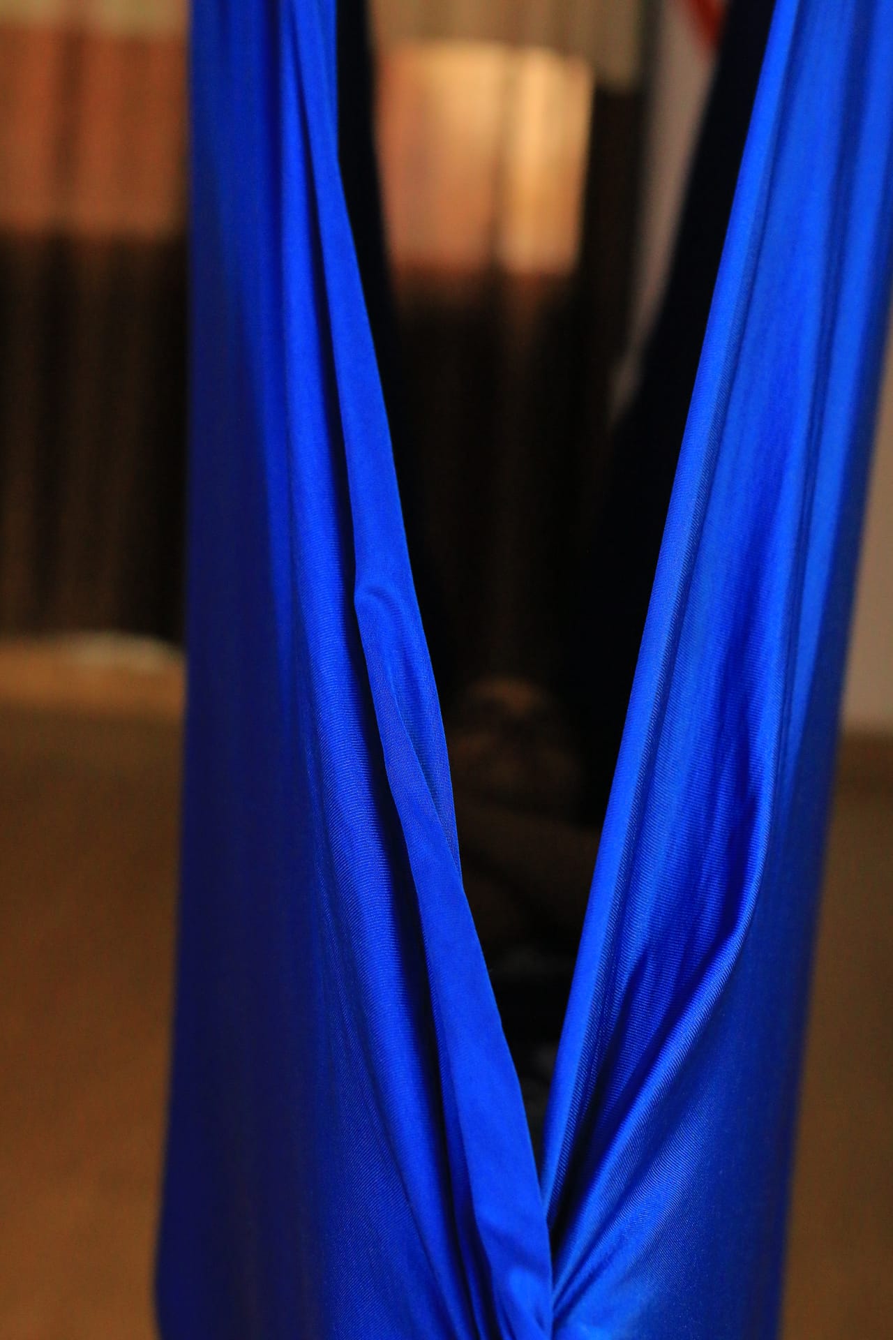 Relaxing cocoon pose in aerial hammock